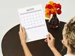 Woman using a free printable 2025 calendar