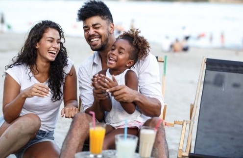 Organizing your life well allows you to enjoy more special moments with your family. Two adults and a child enjoying soft drinks outdoors.