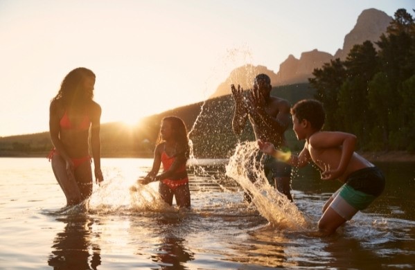 Family Enjoying Time Off Playing in a Lake.