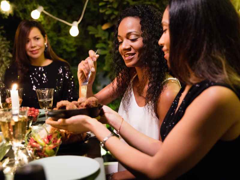 Guests enjoying a meal at a dinner party.
