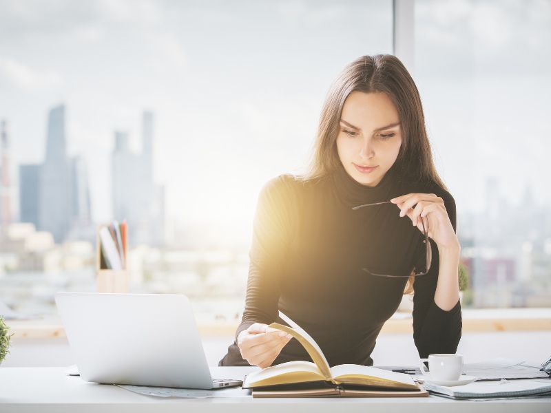 A woman sat at her desk focused on her work task.  A woman sat at her desk focused on her work task.