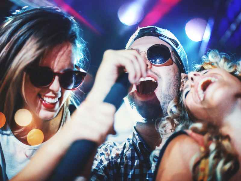 Party entertainment: guests performing karaoke.