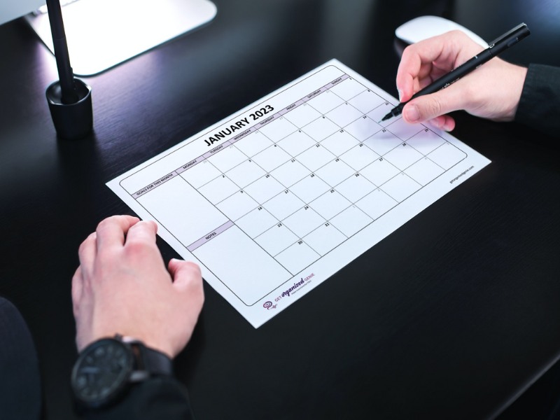 A person using a printable calendar