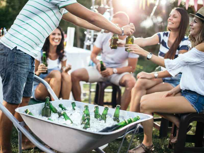 Someone serving drinks to a group of party guests.