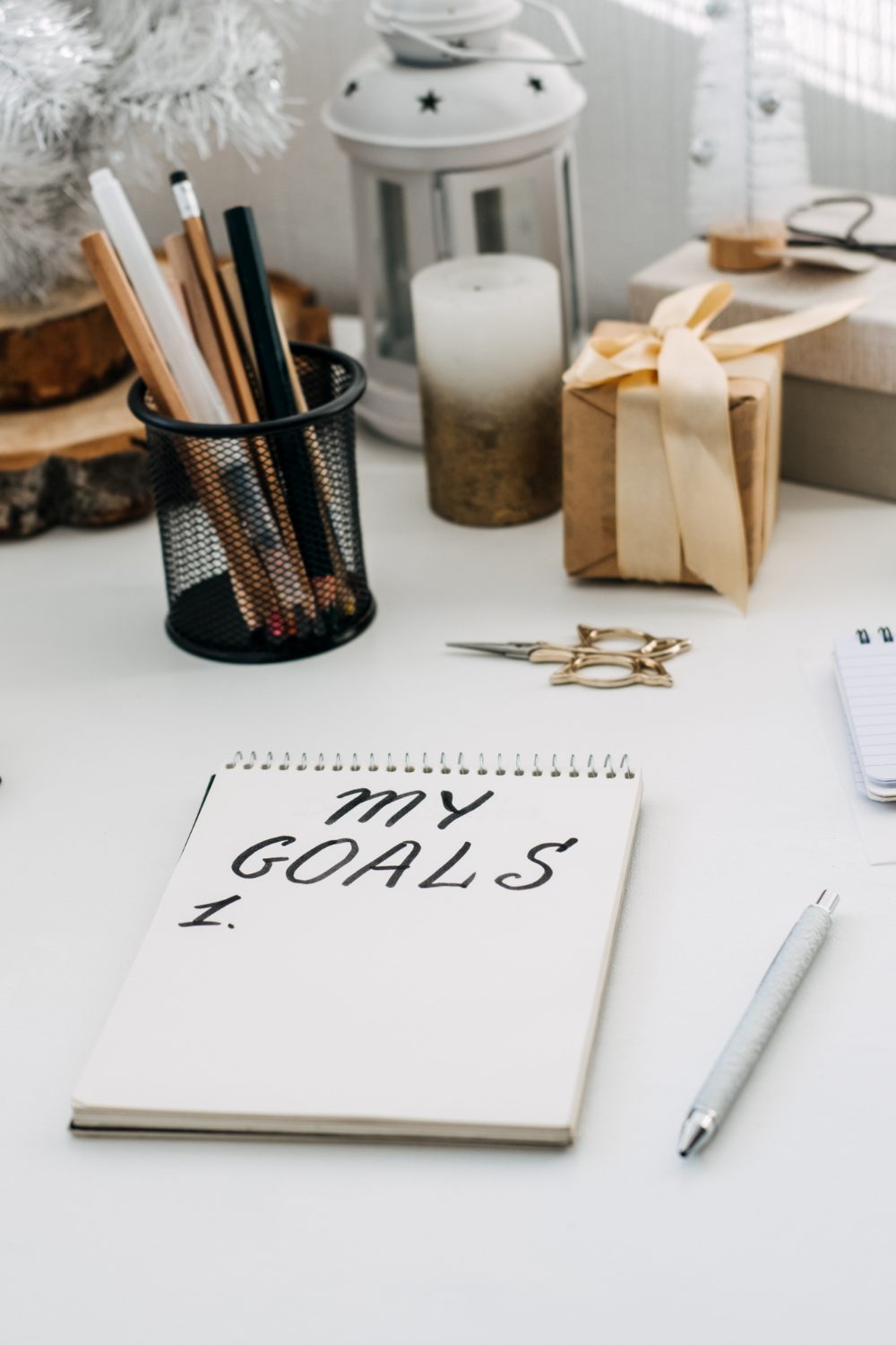 A notepad on a table being used for setting goals.