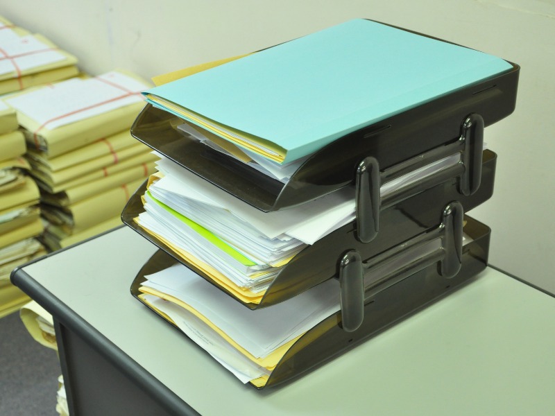 Stackable document trays to organize paper documents.